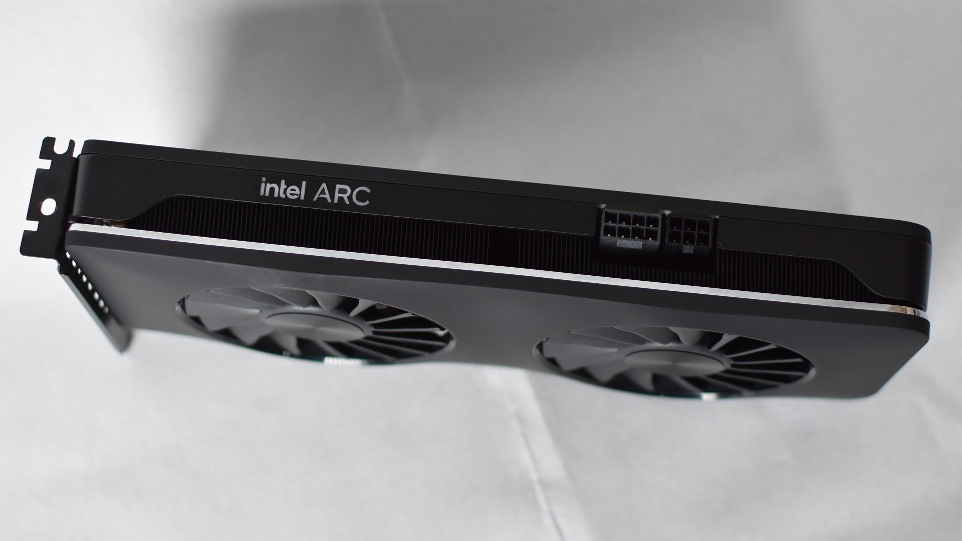 A side view of the Intel Arc A750 Limited Edition graphics card, showing its power connectors.