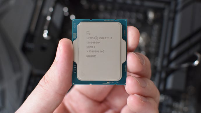An Intel Core i5-14600K CPU being held in a hand.