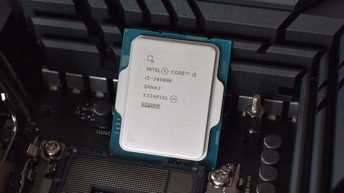 Intel Core i5-14600K CPU propped up against a motherboard heatsink.