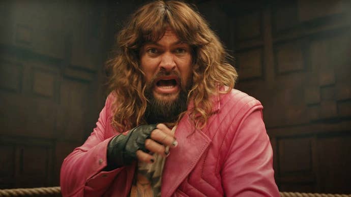 Jason M in A Minecraft Movie wearing a pink jacket and standing in a boxing ring