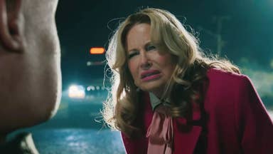 Jennifer Coolidge in A Minecraft Movie wearing a pink coat and looking concerned