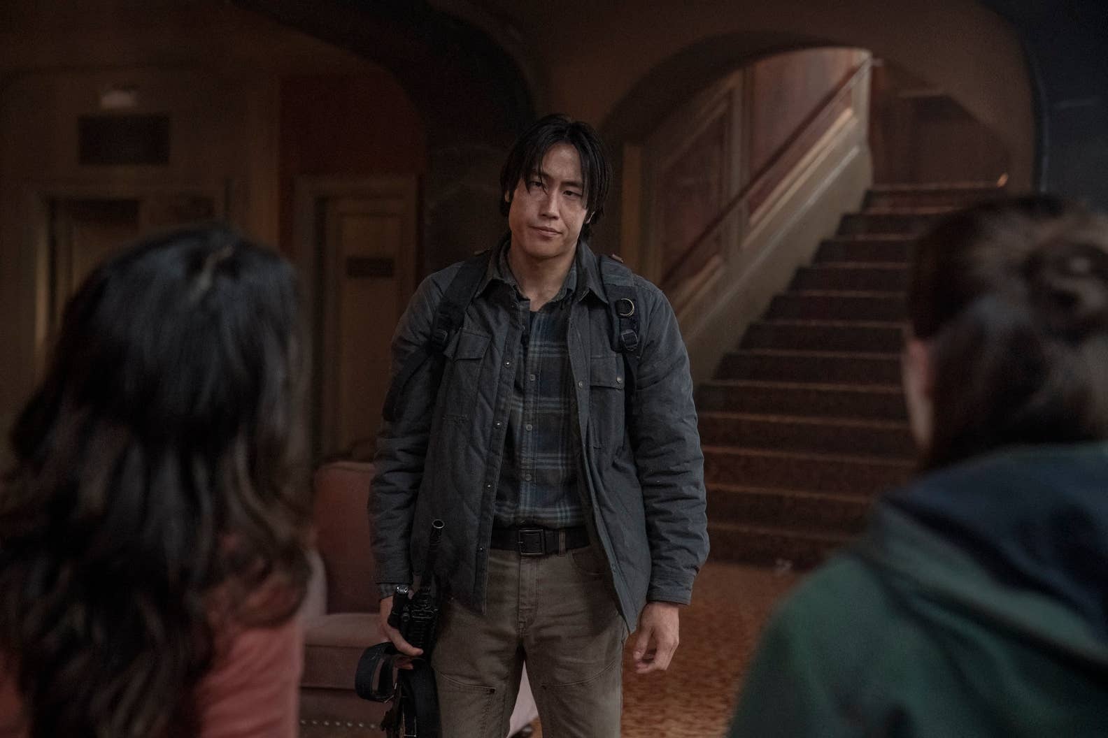Jesse looks at Dina while Ellie stands next to her in TLOU season two