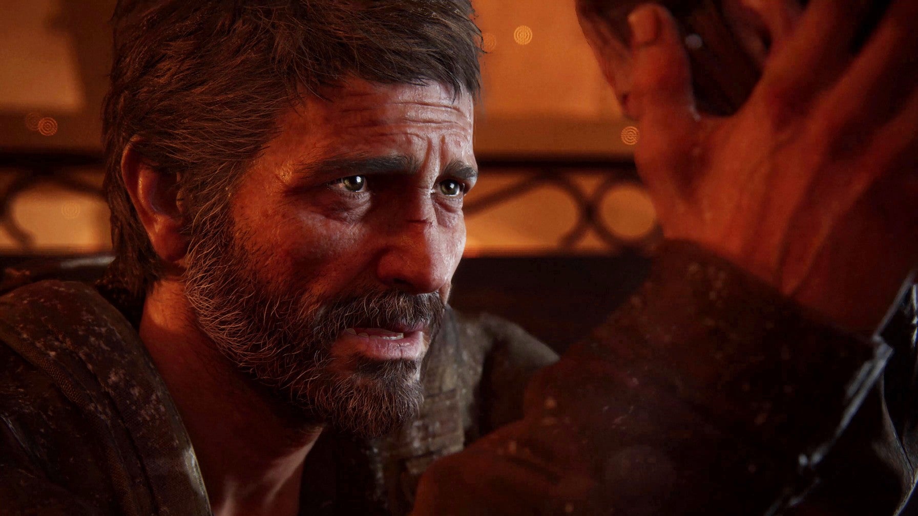 Joel takes Ellie&rsquo;s face in his hands as he looks deep into her eyes in The Last of Us Part 1