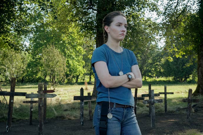 Kaitly Dever as Abby standing in front of homemade graves in The Last of Us season two