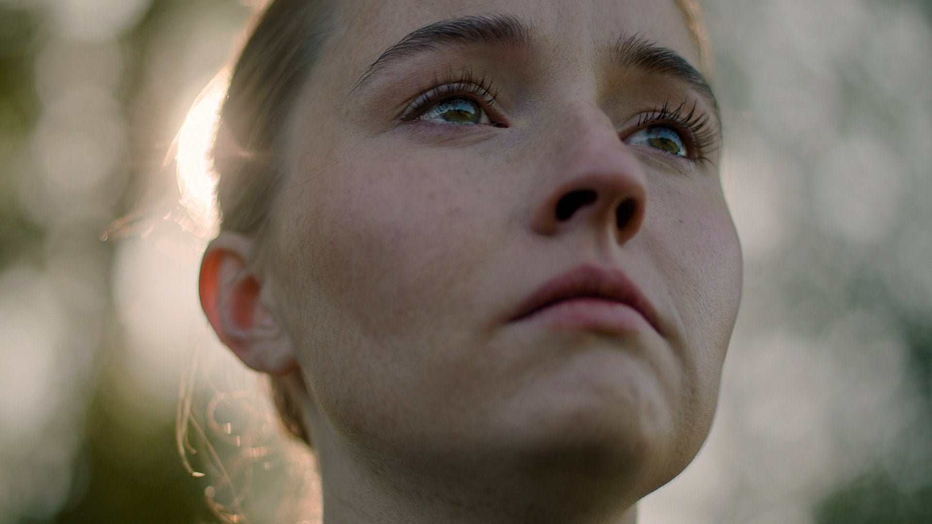 Kaitlyn Dever as Abby in season two of The Last of Us. She has tears in her eyes and a determined look on her face