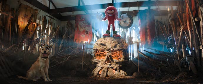 In live action, Knuckles stands on a stone icon in a sloppy gladiatorial arena in the living room.