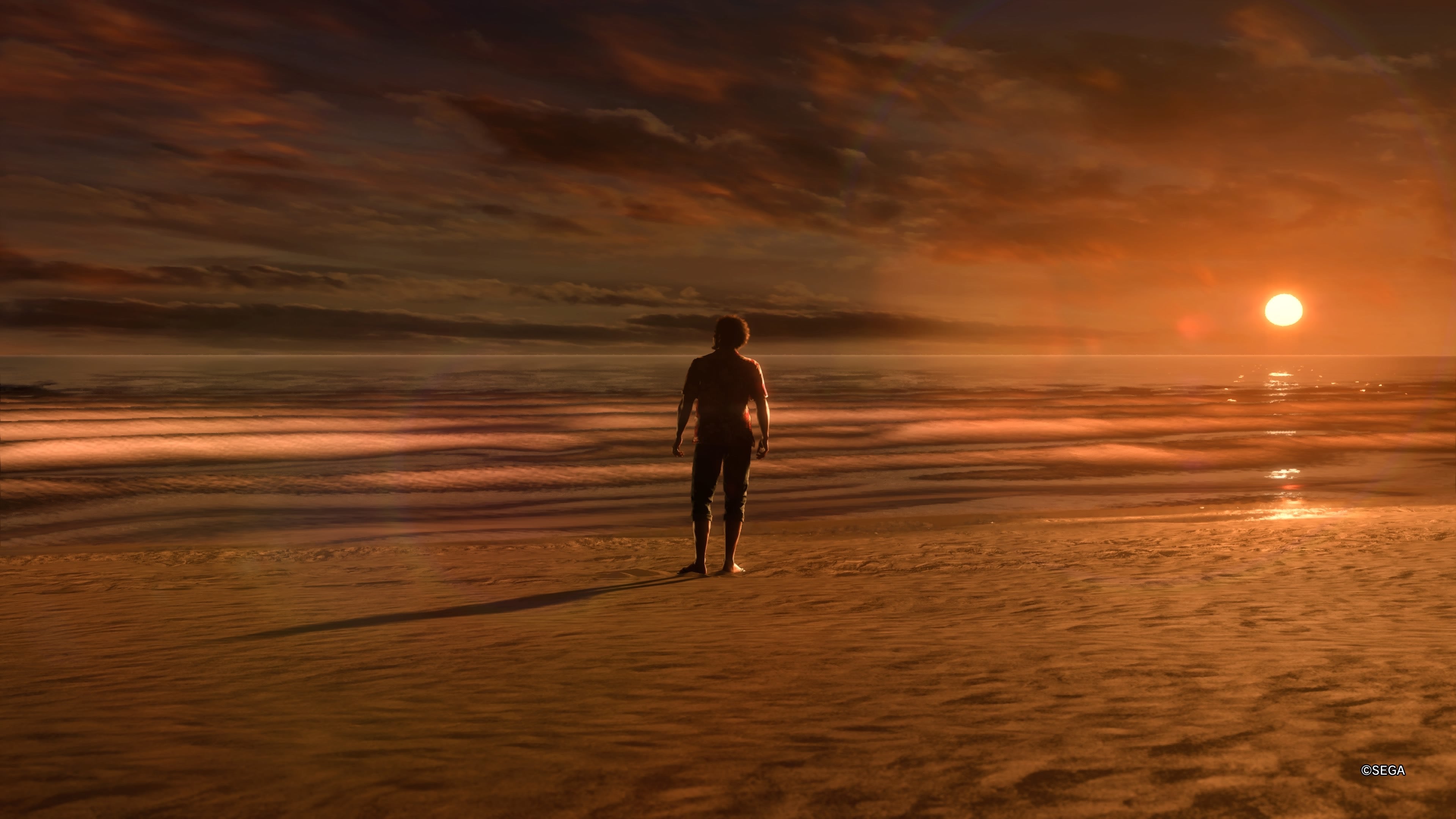 Ichiban looks out into the ocean during sunset in a screenshot from Like A Dragon: Infinite Wealth.