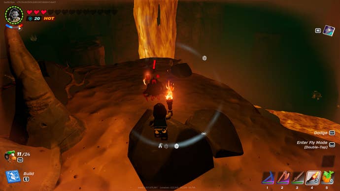 A player looks down at a Blaster inside a Lava Cave in the Dry Valley biome in LEGO Fortnite