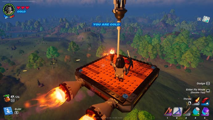 The player stands on a hot air balloon made with a dynamic foundation, thrusters, and a balloon in LEGO Fortnite