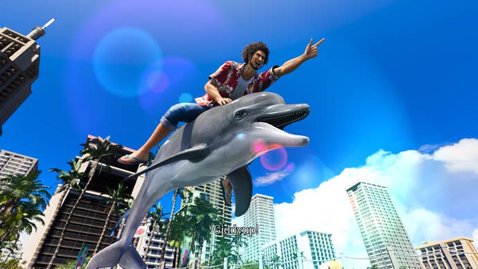 A man riding a dolphin as it leaps in the air. He has a finger pointing forwards as the camera catches the sunlight