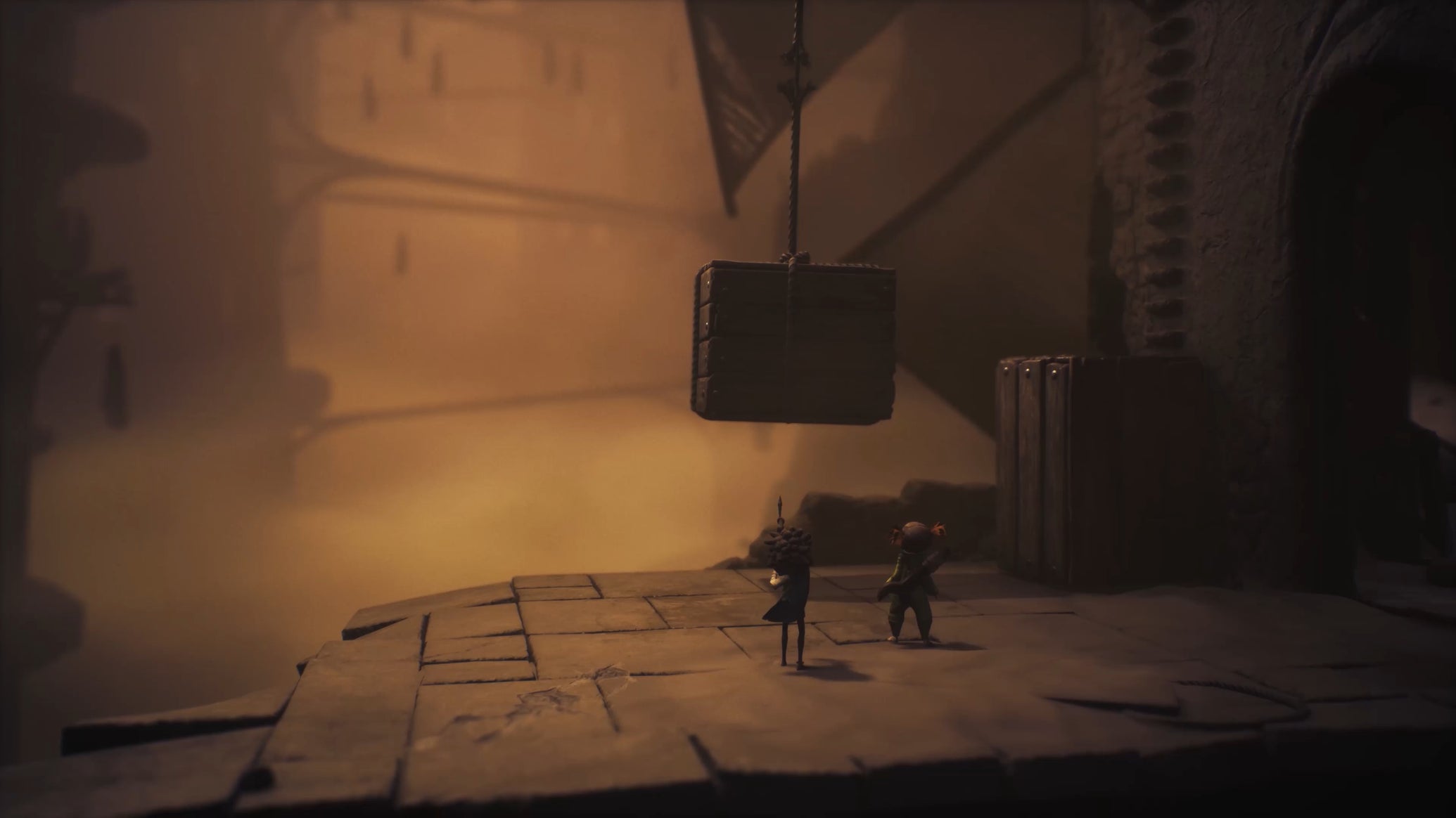 Alone and Low climbing a stone block in Little Nightmares 3. - 1