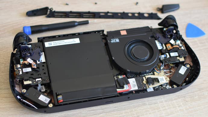 A Lenovo Legion Go S with its rear casing removed, showing the handheld PC's internals and SSD.