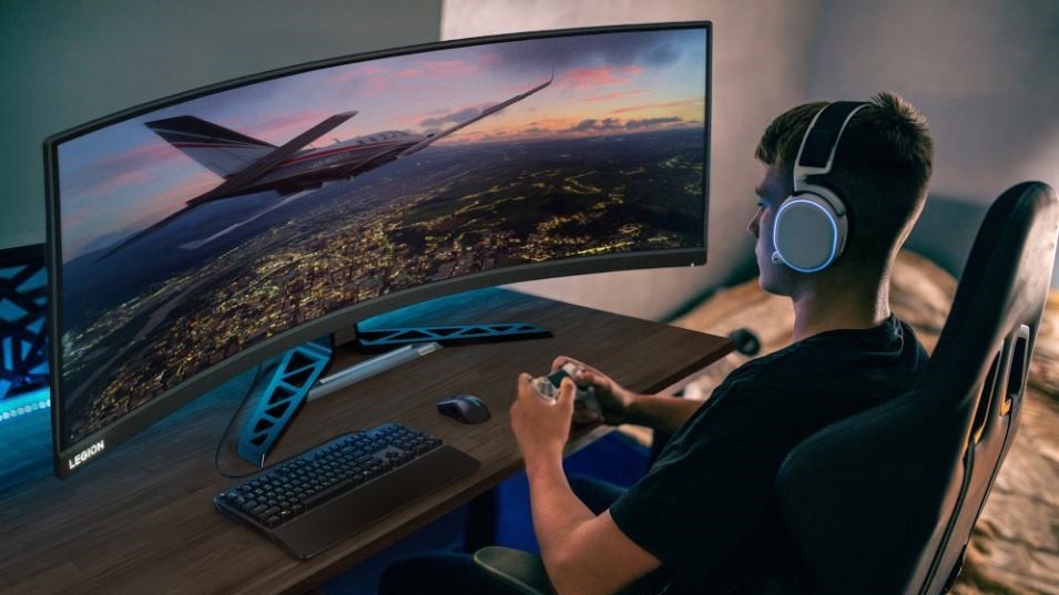 A man playing games on the Lenovo Legion R45w-30 monitor.