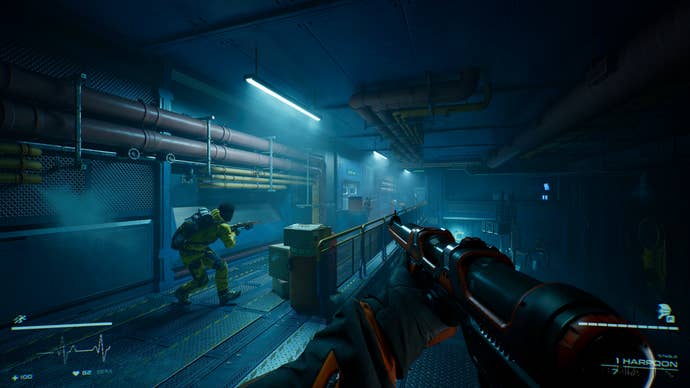 The players hide behind crates in a corridor while aiming their guns in Level Zero