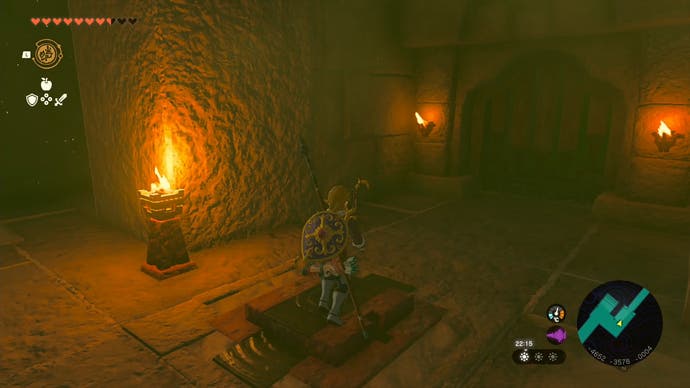 Link standing on a switch in the Lightning Temple which brings a number of dangerous fireballs to a stop.