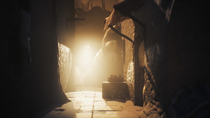The Monster Baby looks down an alley and tries to catch Low and Alone in Little Nightmares 3
