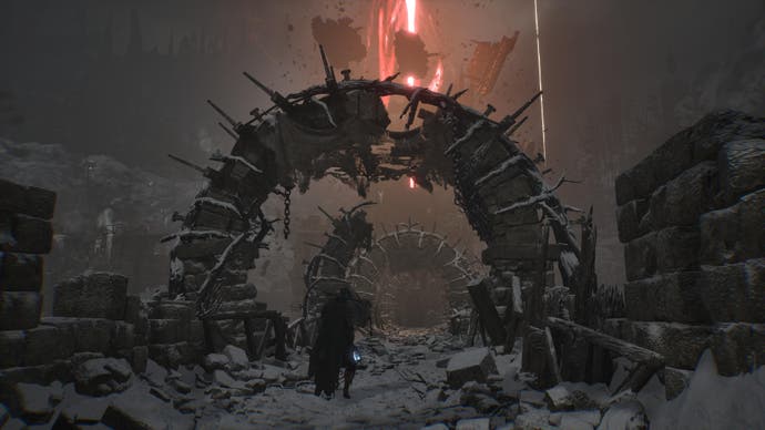 Player character in Lords of the Fallen in the snow under ruined archway