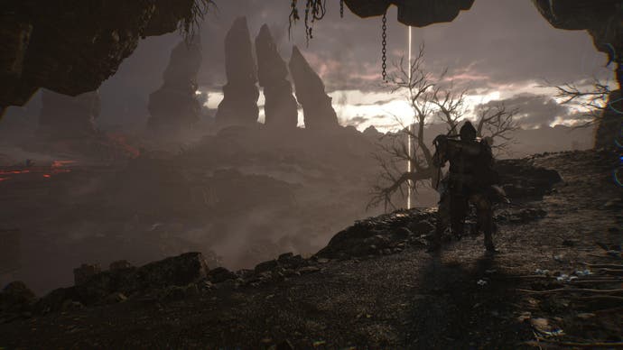 Player character in Lords of the Fallen looks out at distant mountains in the sunrise