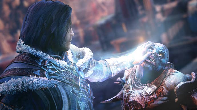 screenshot from shadow of mordor showing a human character pushing down on the face of an orc