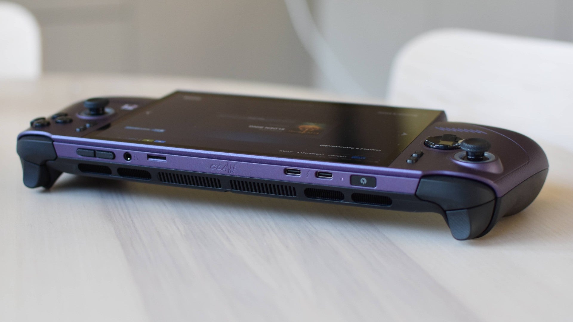 An MSI Claw 8 EX AI+ on a table, with the camera facing its top edge.