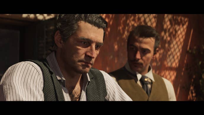 Two masculine characters in a cutscene moment, both in shirts and waistcoats and neatly coiffured. One has a stern face as if they're recollecting something painful.