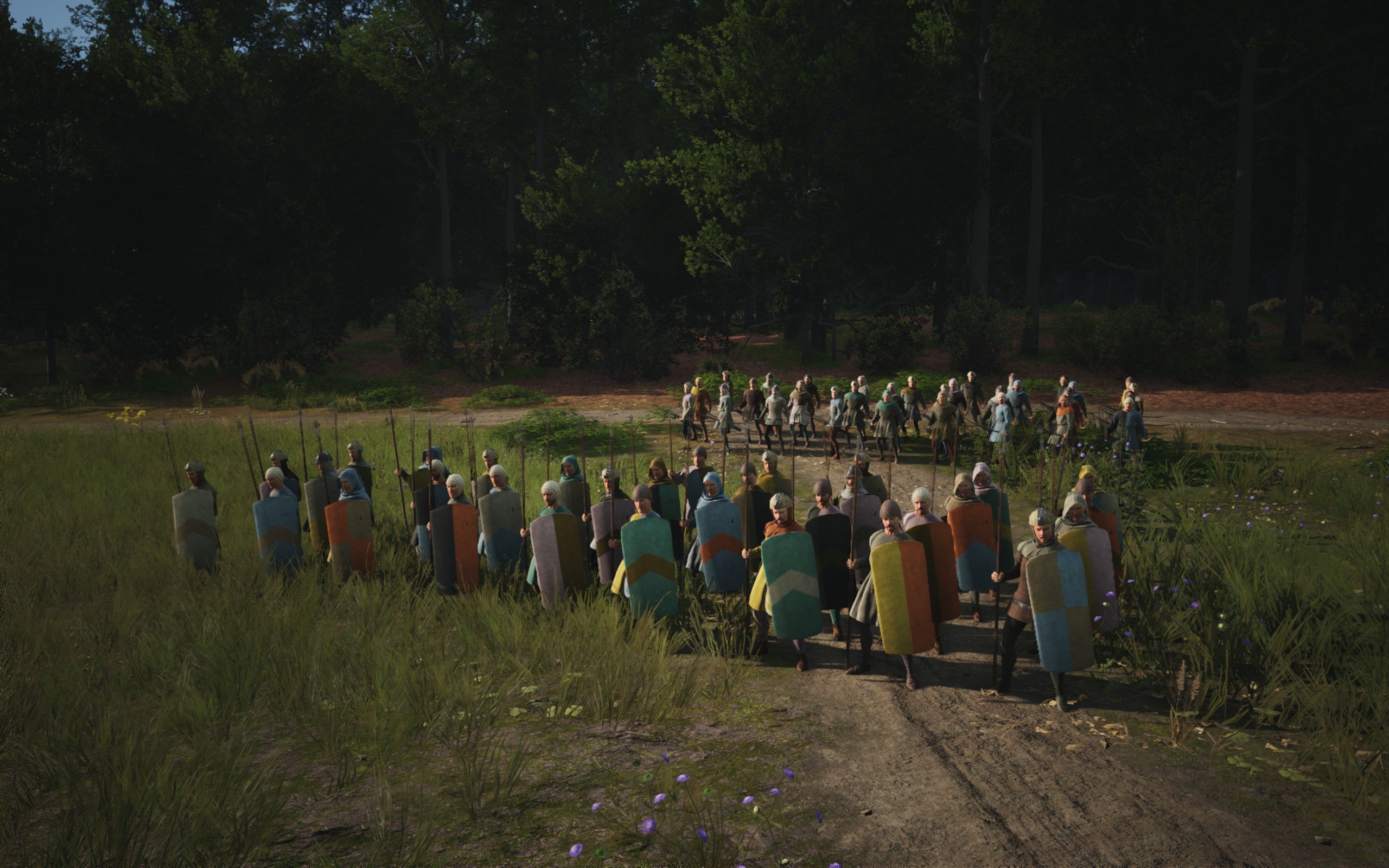 Two squads of Militia line up in front of a forest in Manor Lords