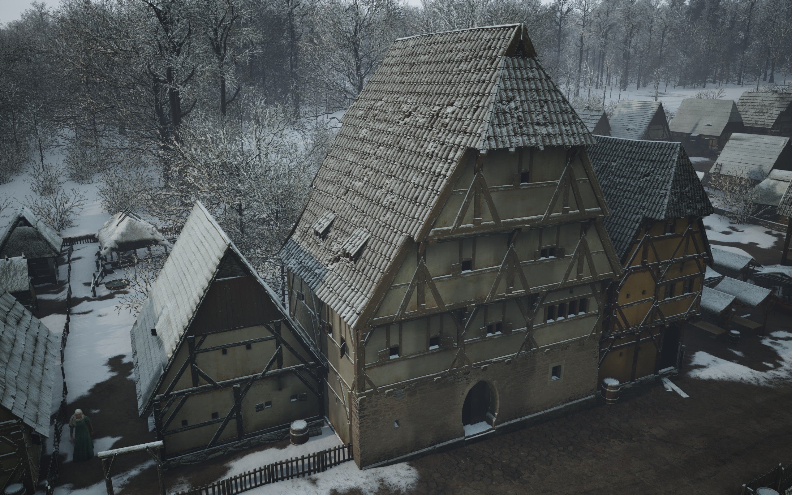 A large manor building in Manor Lords during the winter
