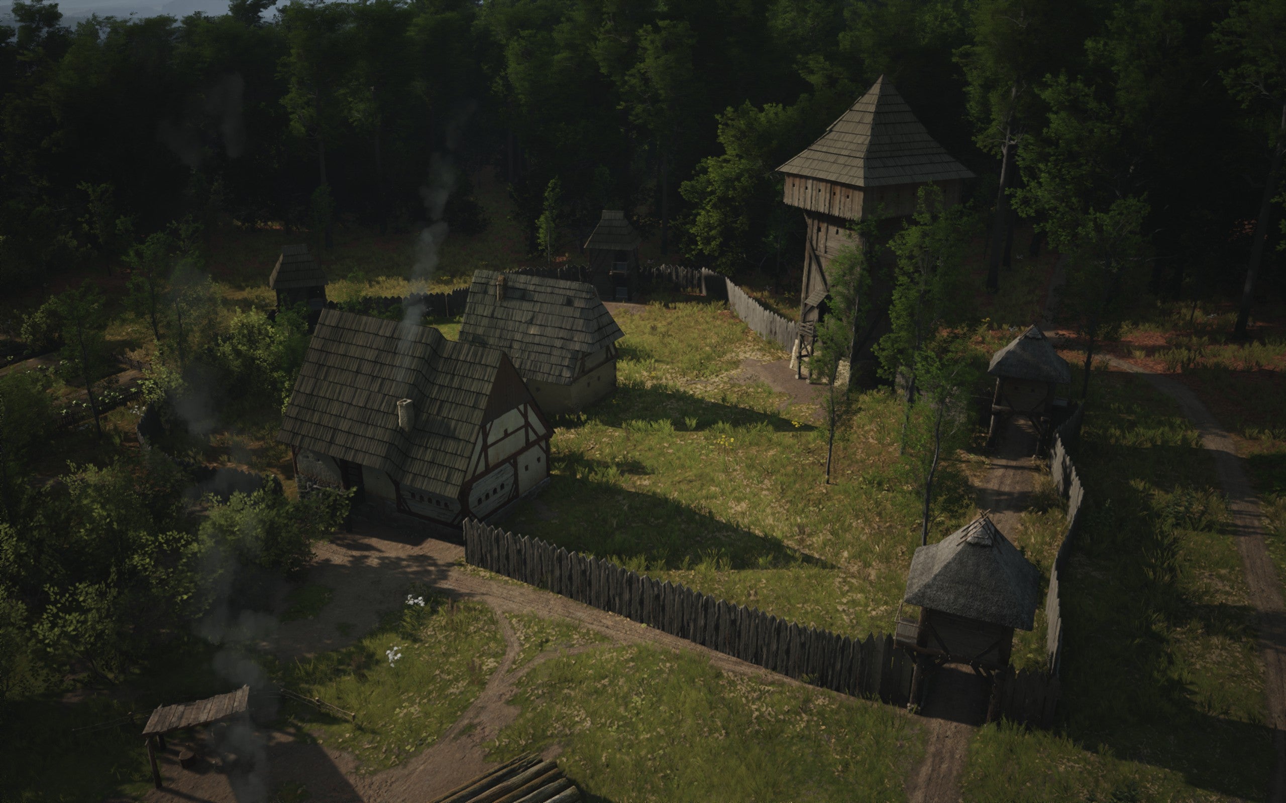 A top down view of a Manor building surrounded by wooden walls in Manor Lords.