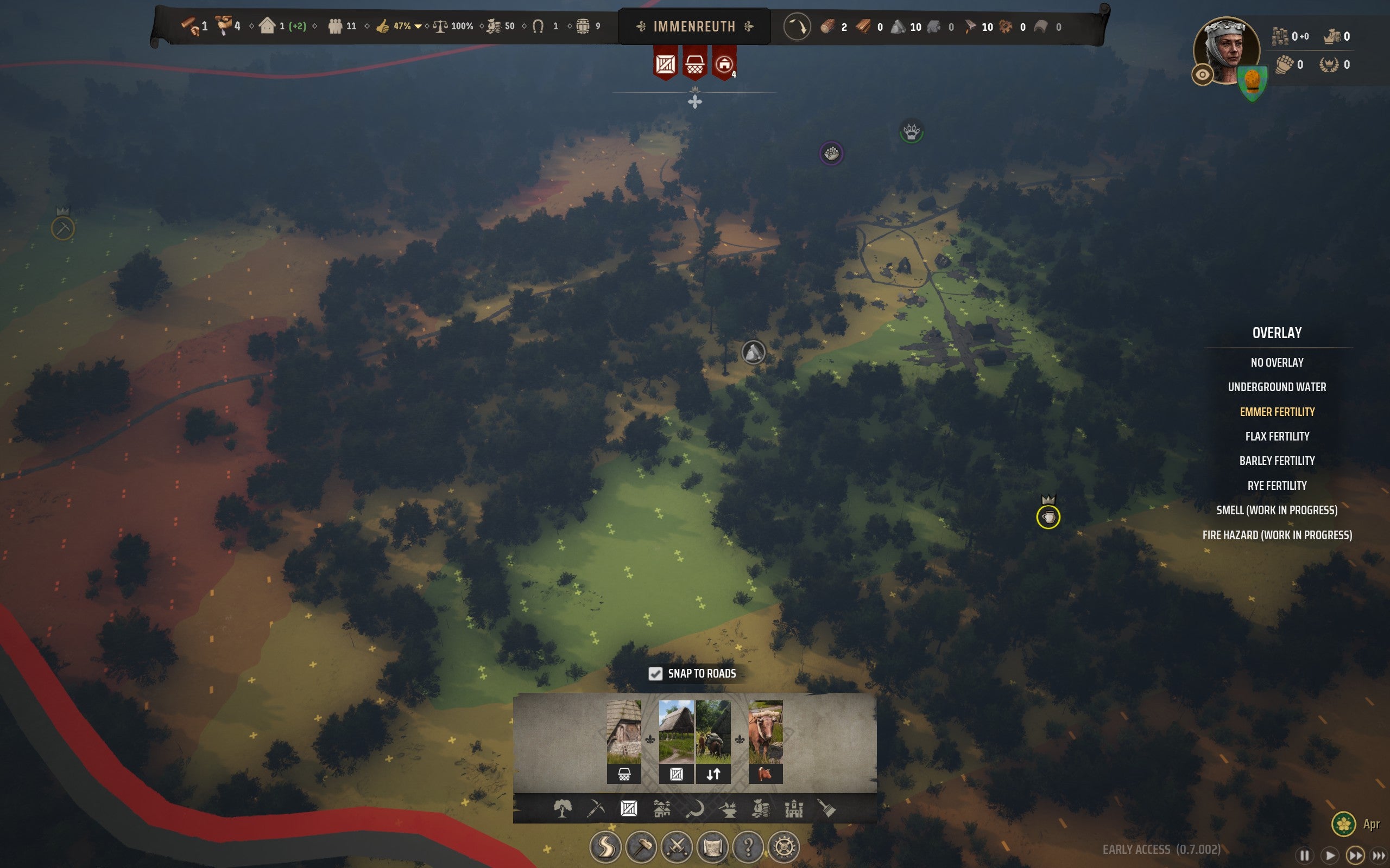 An overhead map of a forested region showing a soil fertility overlay in Manor Lords
