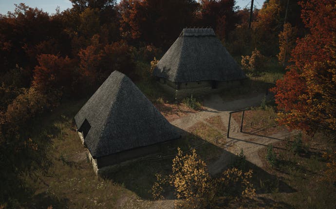 Two farming huts surrounded by autumnal trees in Manor Lords
