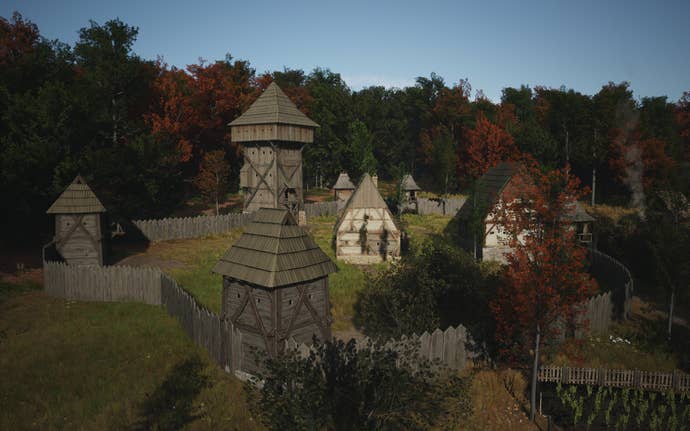 A view of a well developed Manor building inside wooden walls in Manor Lords