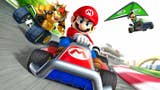 Mario Kart 7 promo image showing Mario front and centre in a red a blue kart. Bowser is coming up on his left (as you look at the pic) while Luigi soars through the air on the right with a green glider attached to his kart
