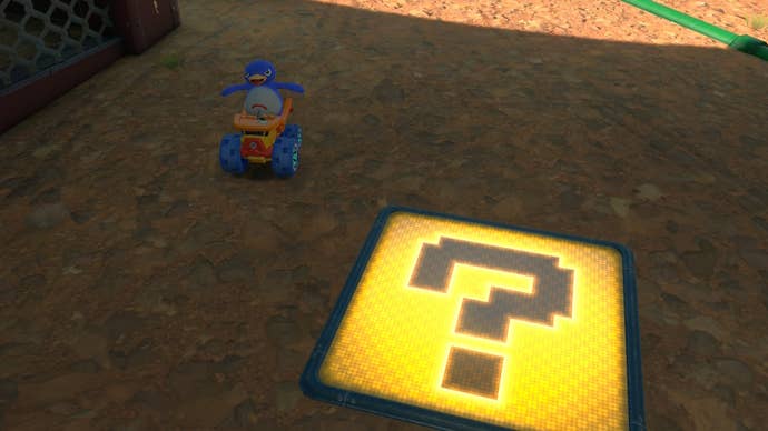 The Penguin, who is riding the Lil Dumpy, poses beside a Hidden ? Panel in Mario Kart World