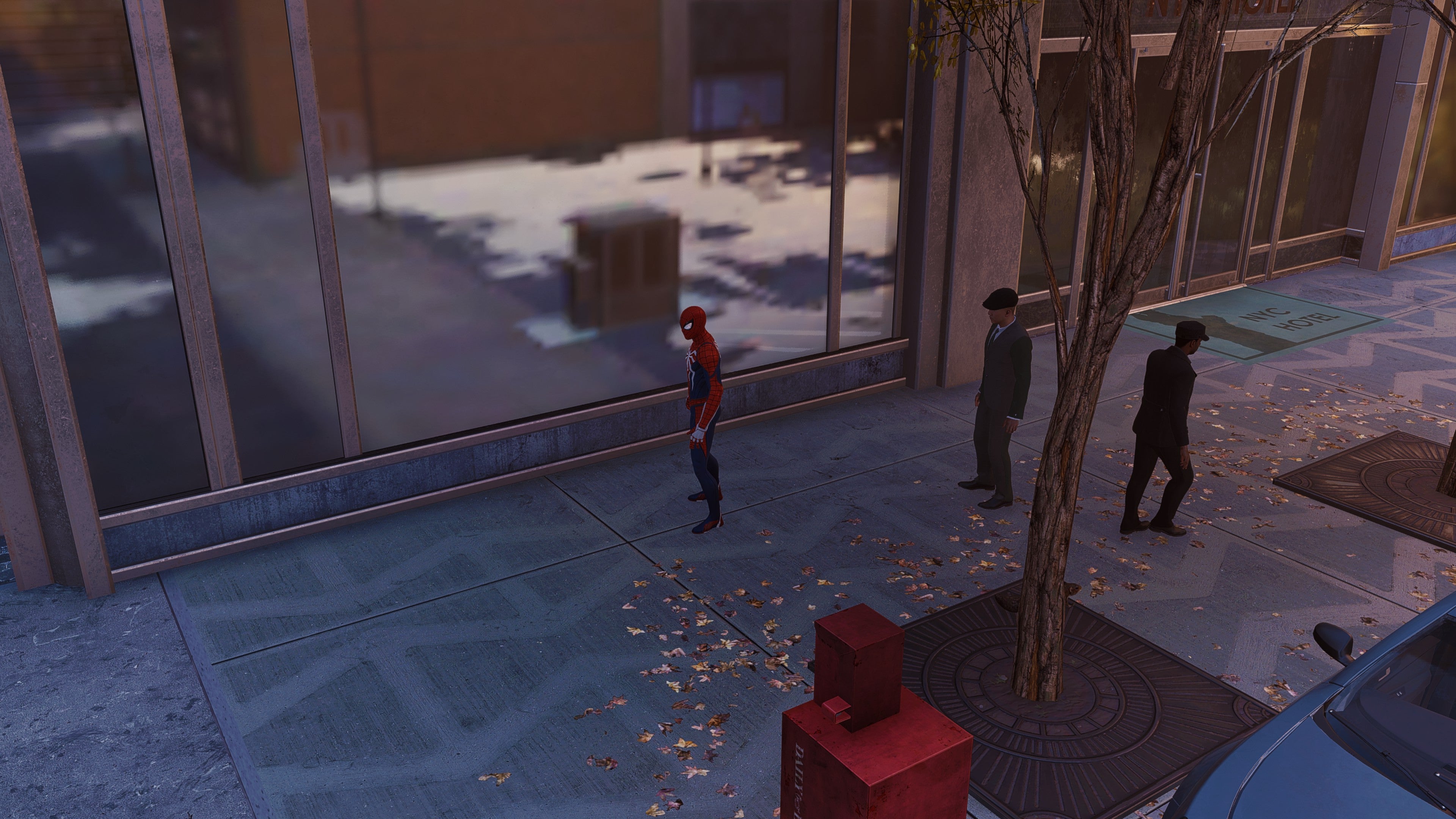 Spider-Man stands in front of a window in Marvel&rsquo;s Spider-Man Remastered.