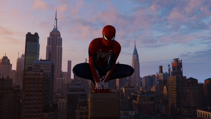 Spider-Man perches atop a building, New York skyline in the background, in Marvel’s Spider-Man Remastered.