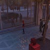 Spider-Man stands in front of a window in Marvel’s Spider-Man Remastered, with ray tracing enabled.