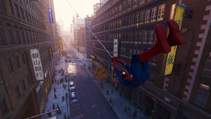 Spider-Man swings down a Manhattan street in Marvel’s Spider-Man Remastered.