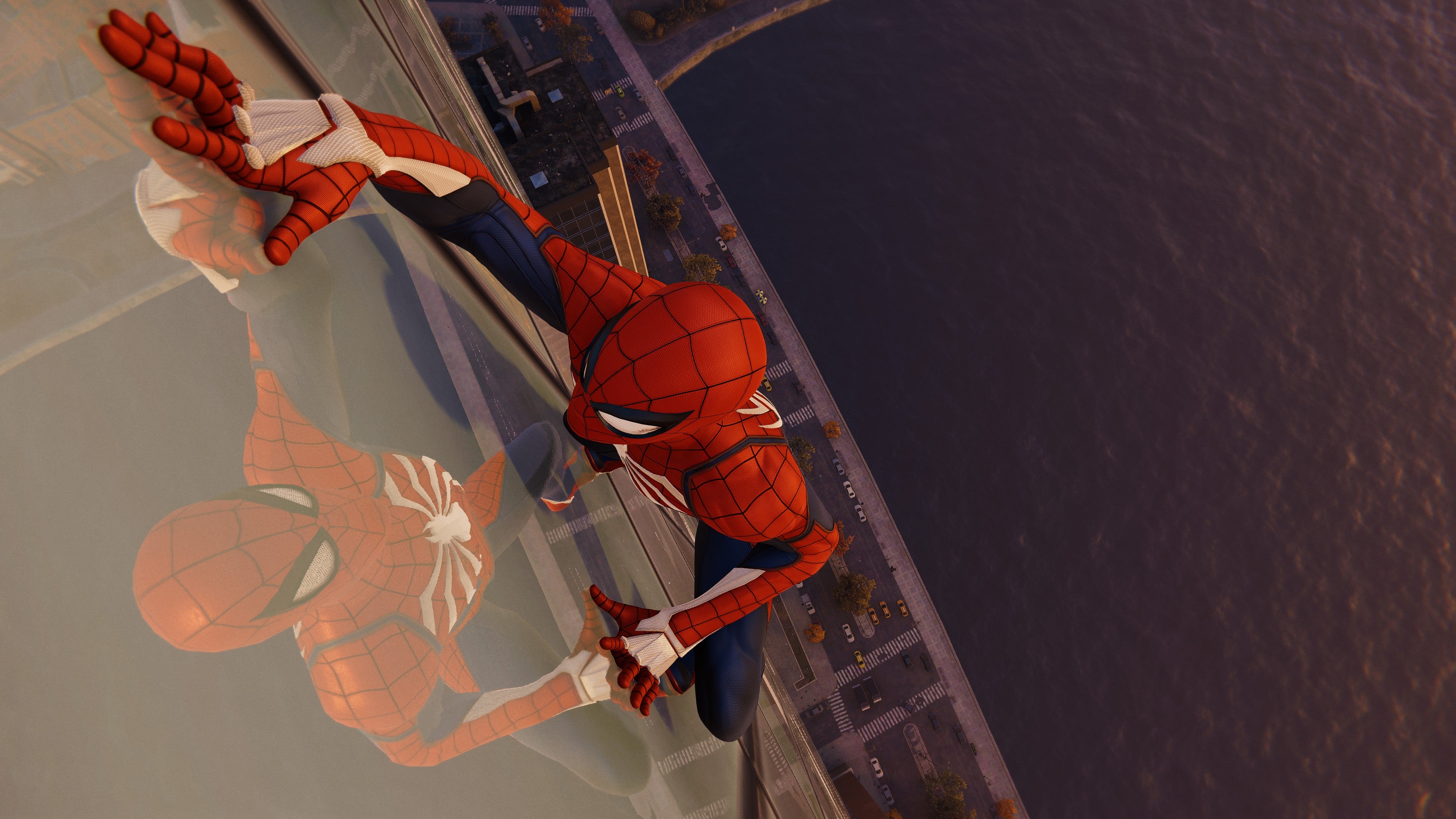 Spider-Man crawls up a skyscraper in Marvel&rsquo;s Spider-Man Remastered.