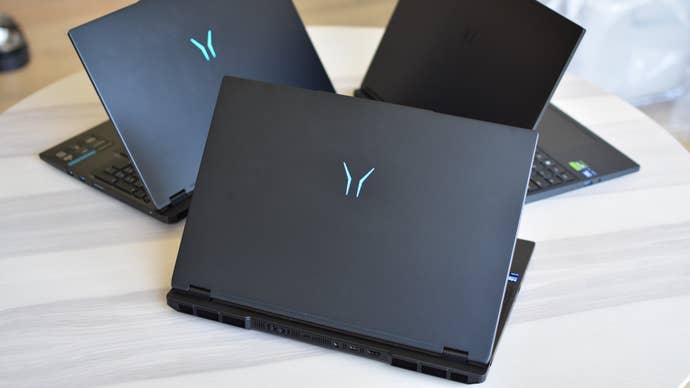 Three Medion Erazer gaming laptops connected a table, unfastened but with their lids facing the camera.