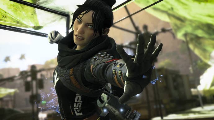 Screenshot of Wraith from Apex Legends, in black gear holding out her hand ready to punch