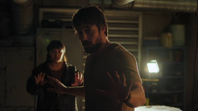 Mel and Owen in The Last of Us season two with their hands up