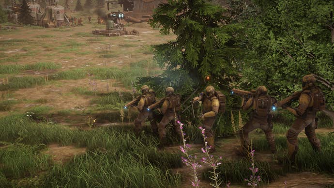 Marines line up in a treeline in Menace.