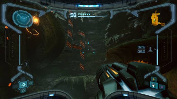 Samus looks over at a Spider Ball track in Metroid Prime Remastered
