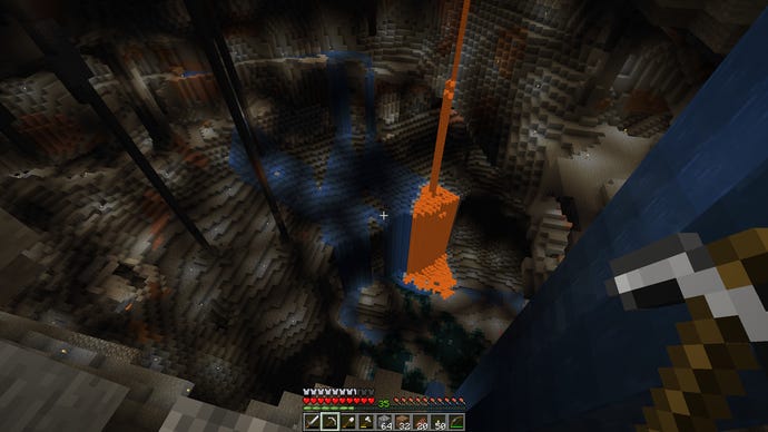 A huge underground cavern in Minecraft, lit up with placed torches.