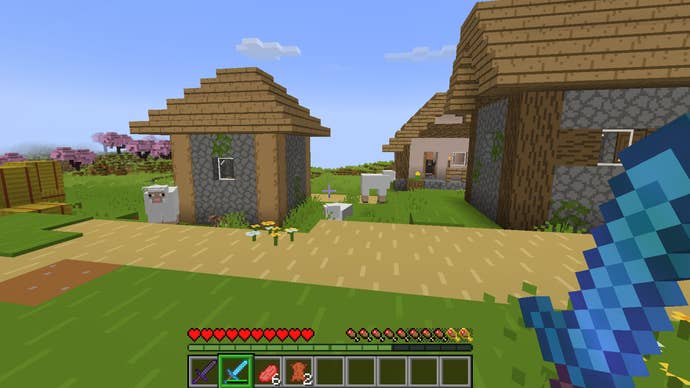 The player looks at a village with the Bare Bones texture pack enabled in Minecraft