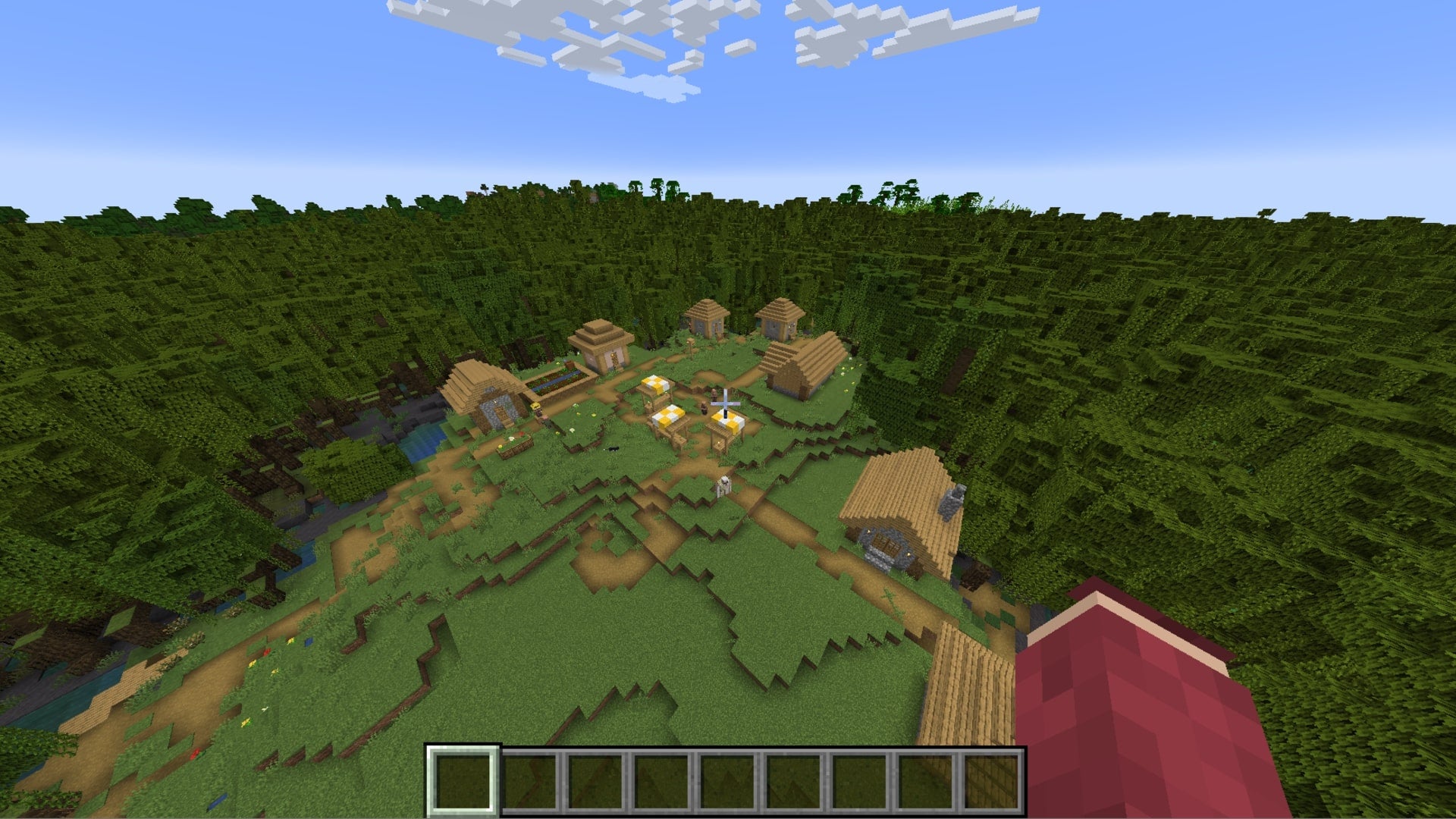 The player looks down at a village in the middle of a huge mangrove swamp in Minecraft