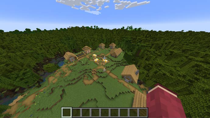 The player looks down at a village in the middle of a huge mangrove swamp in Minecraft