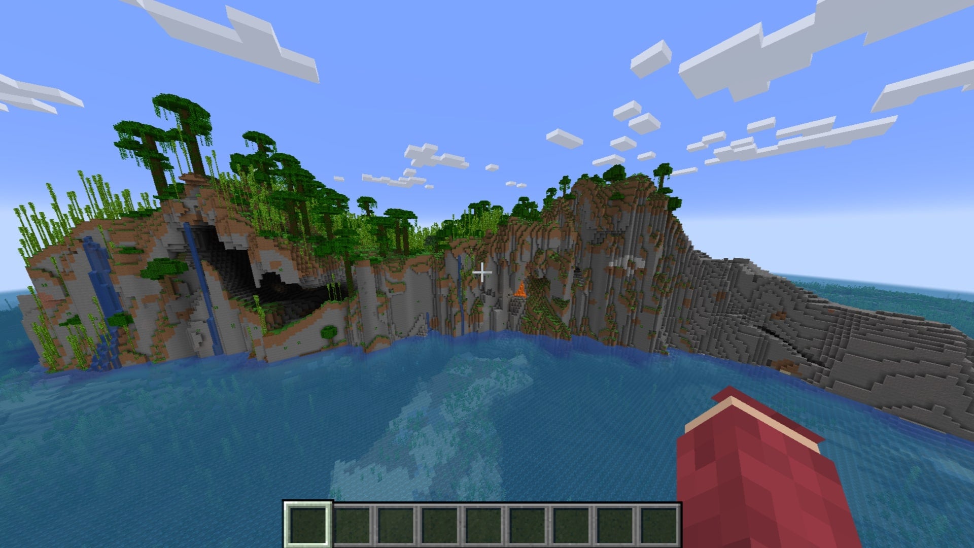 The player looks over at a huge cliff island with a jungle biome atop it in Minecraft