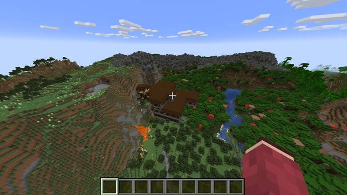 The player looks down at a woodland mansion with an outpost tower on top of it in Minecraft