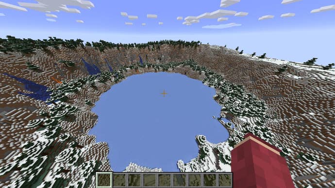 The player looks down at a huge circular frozen lake surrounded by mountains, caves, and an outpost in Minecraft